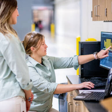 Undergraduate students using a computer and Laptop